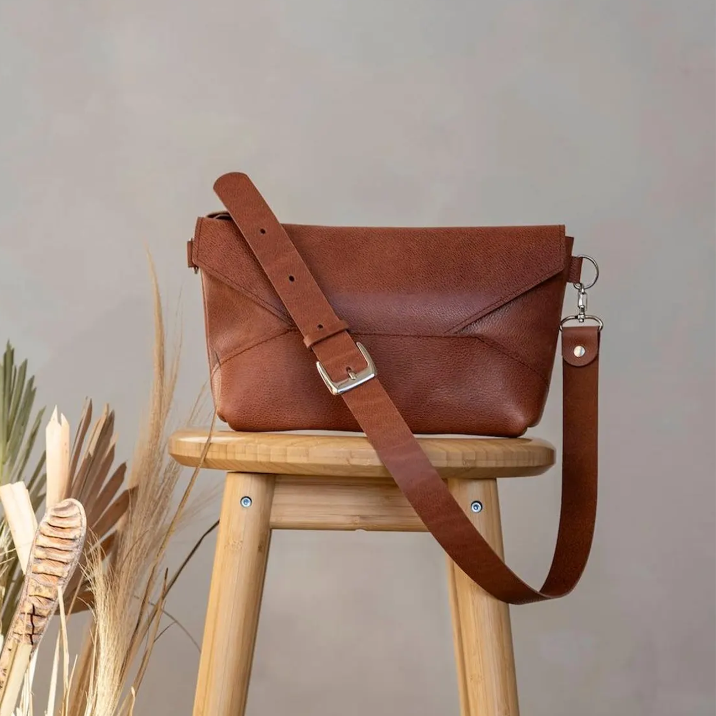 Warm Russet Brown Geometric Fold Envelope Shoulder Pouch With Origami Panel Detailing, Polished Metal Buckle Carry Strap And Side Ring Hardware Fasteners