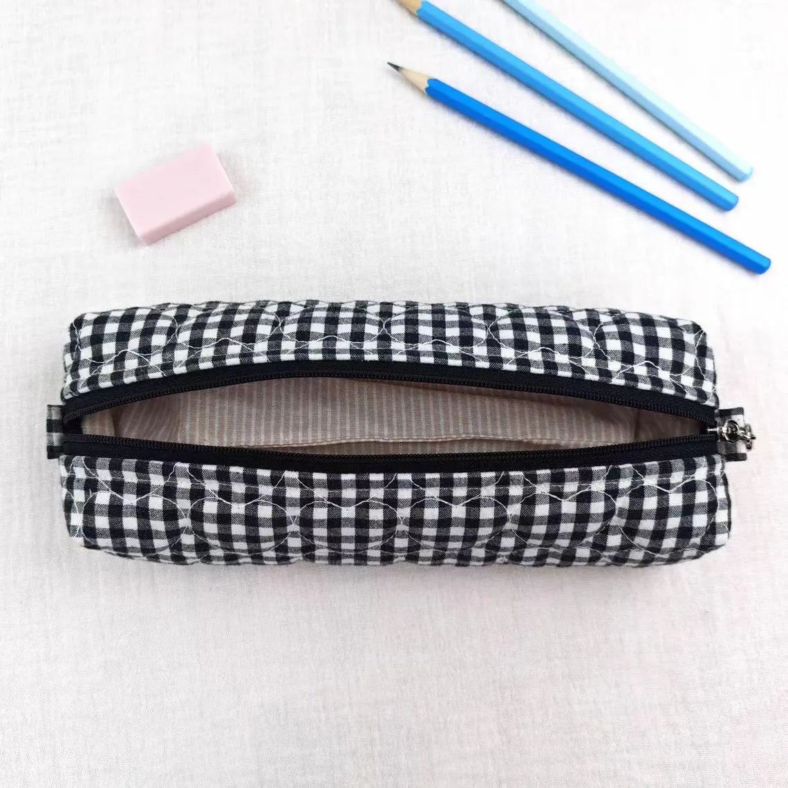 Black White Grid Print Elongated Cylindrical Quilted Stationery Pouch With Heart Stitch Detailing And Full Width Top Slide Zipper Closure