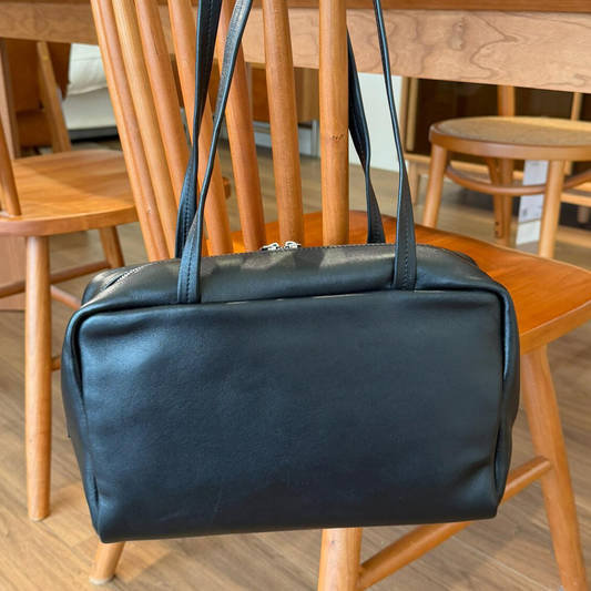 Sleek Solid Black Soft Rectangular Bowling Shoulder Carryall With Full Length Metallic Slide Seal And Dual Slim Stitched Top Grip Strip Shoulder Bag