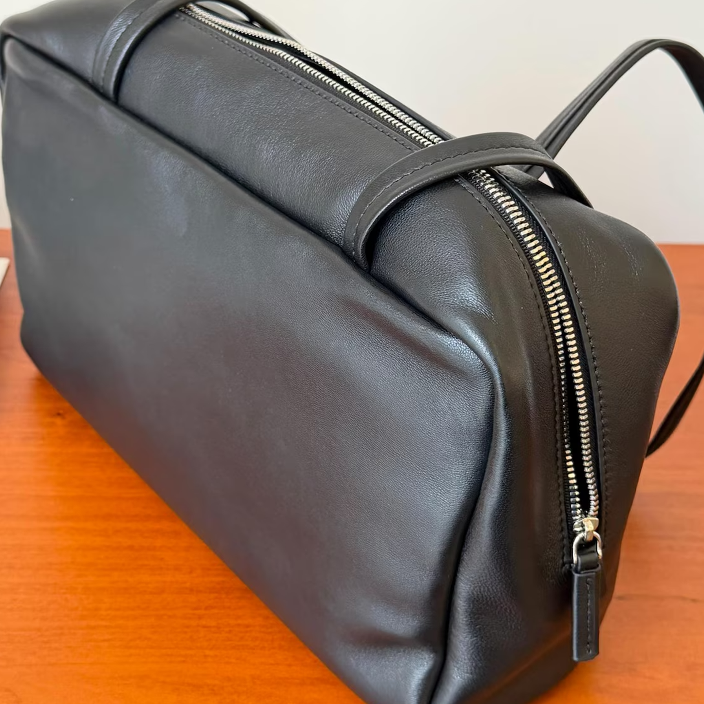 Sleek Solid Black Soft Rectangular Bowling Shoulder Carryall With Full Length Metallic Slide Seal And Dual Slim Stitched Top Grip Strip Shoulder Bag