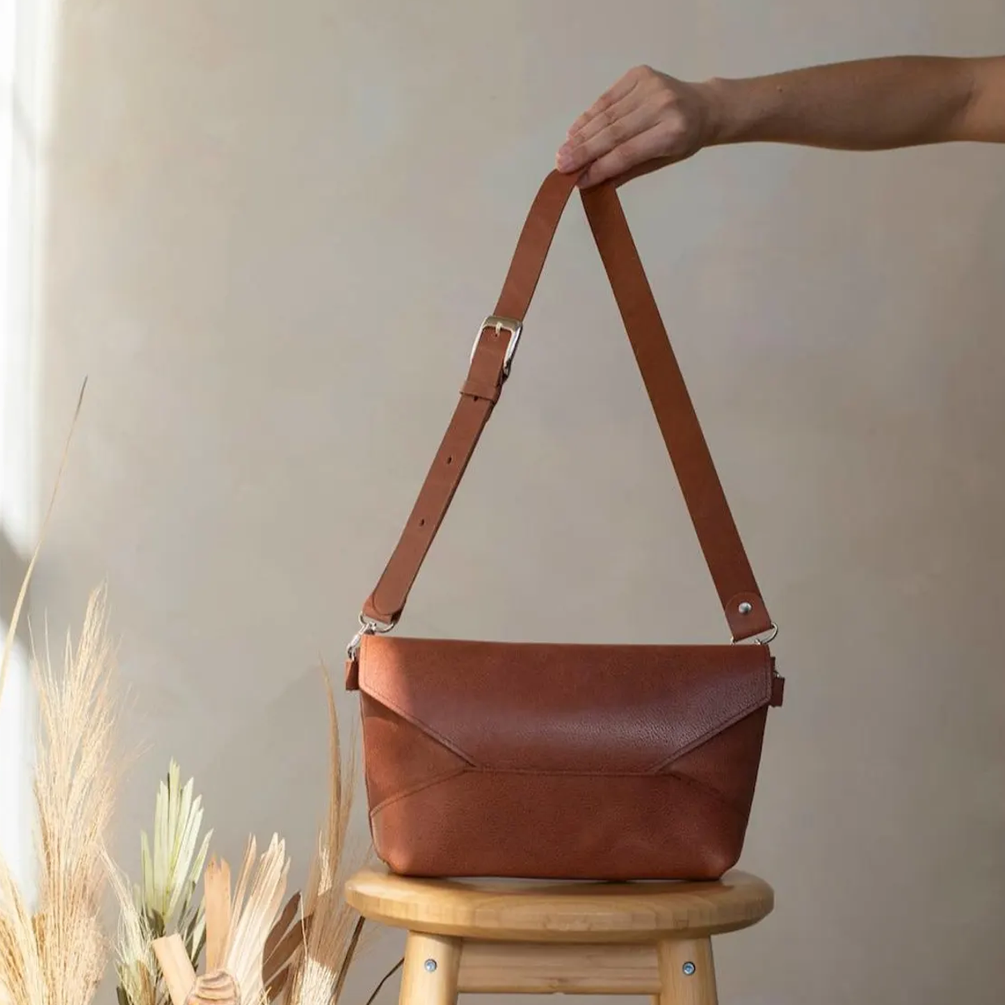 Warm Russet Brown Geometric Fold Envelope Shoulder Pouch With Origami Panel Detailing, Polished Metal Buckle Carry Strap And Side Ring Hardware Fasteners
