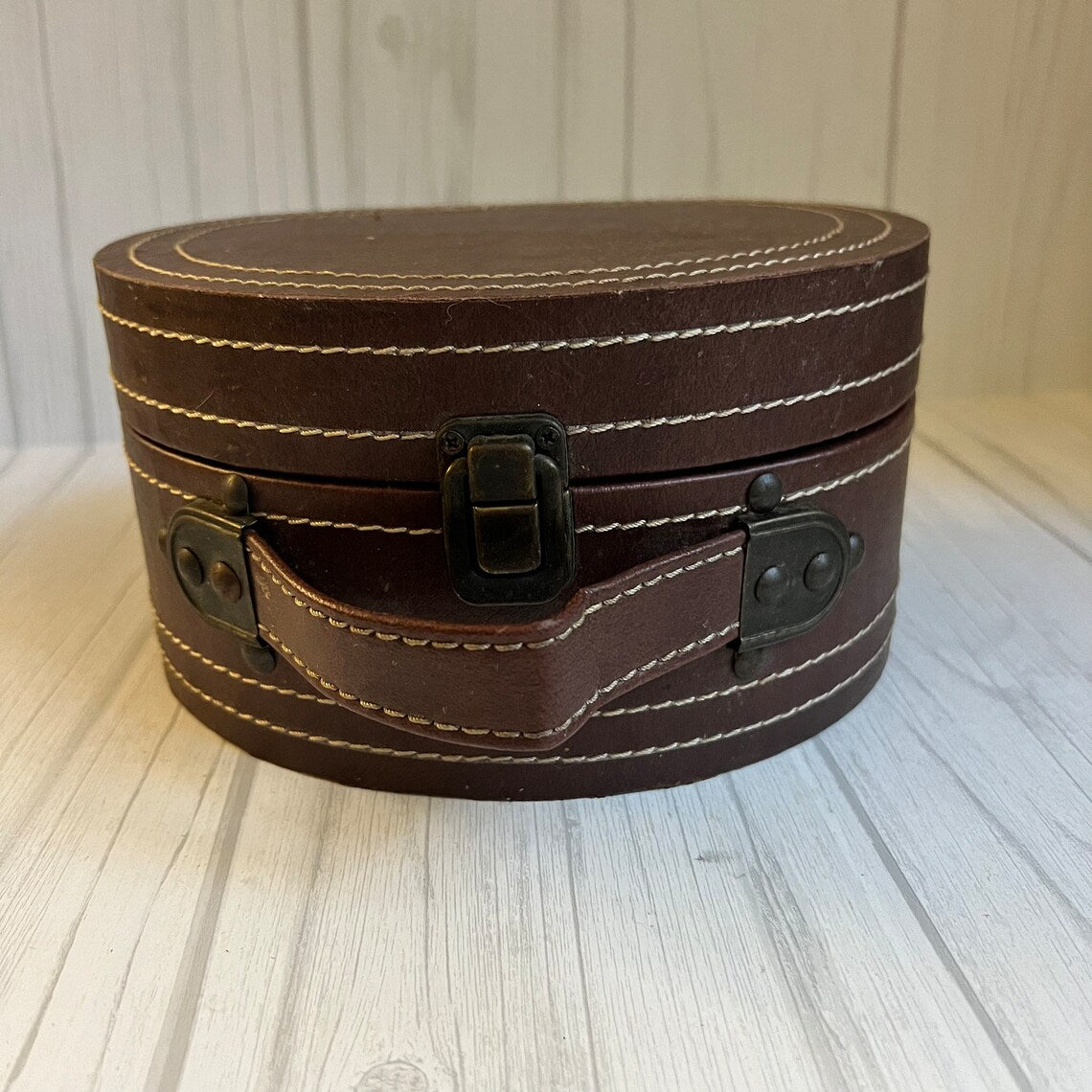 Rich Warm Brown Compact Oval Vintage Carry Case With Concentric Contrast Stitching, Antique Metal Latch Hardware And Single Curved Front Hand Grip