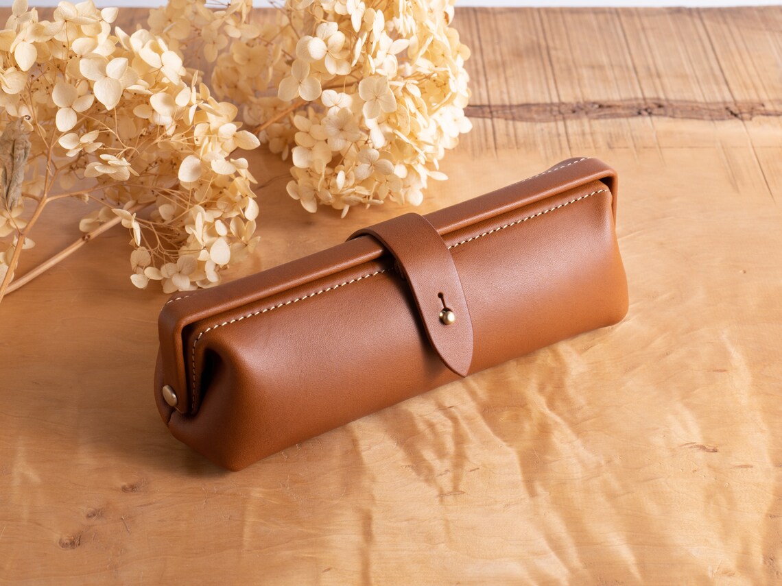 Warm Cognac Brown Rounded Barrel Stationery Holder With Contrast Edge Stitching, Wrap-Around Brass Snap Tab And Vintage Doctor Bag Silhouette