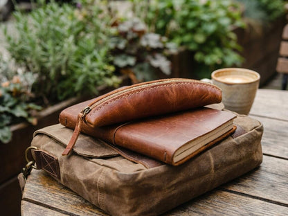 Aged Cognac Brown Slim Curved Stationery Sleeve With Fine Edge Stitching, Antique Brass Slide Closure And Handcrafted Fabric Zip Pull Tab