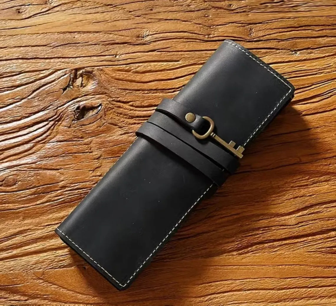 Matte Jet Black Slim Elongated Stationery Wrap With Contrast Edge Stitching, Wraparound Fastening Band And Antique Key Decor Accent